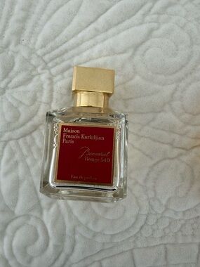 Maison Francis Kurkdjian perfume bottle with red label and gold cap